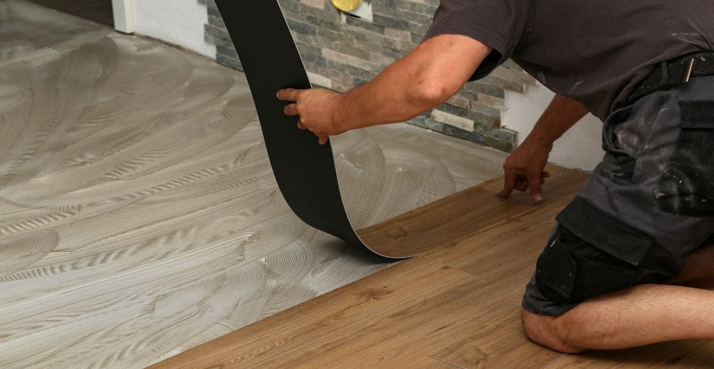 professional flooring expert installing vinyl floor panels